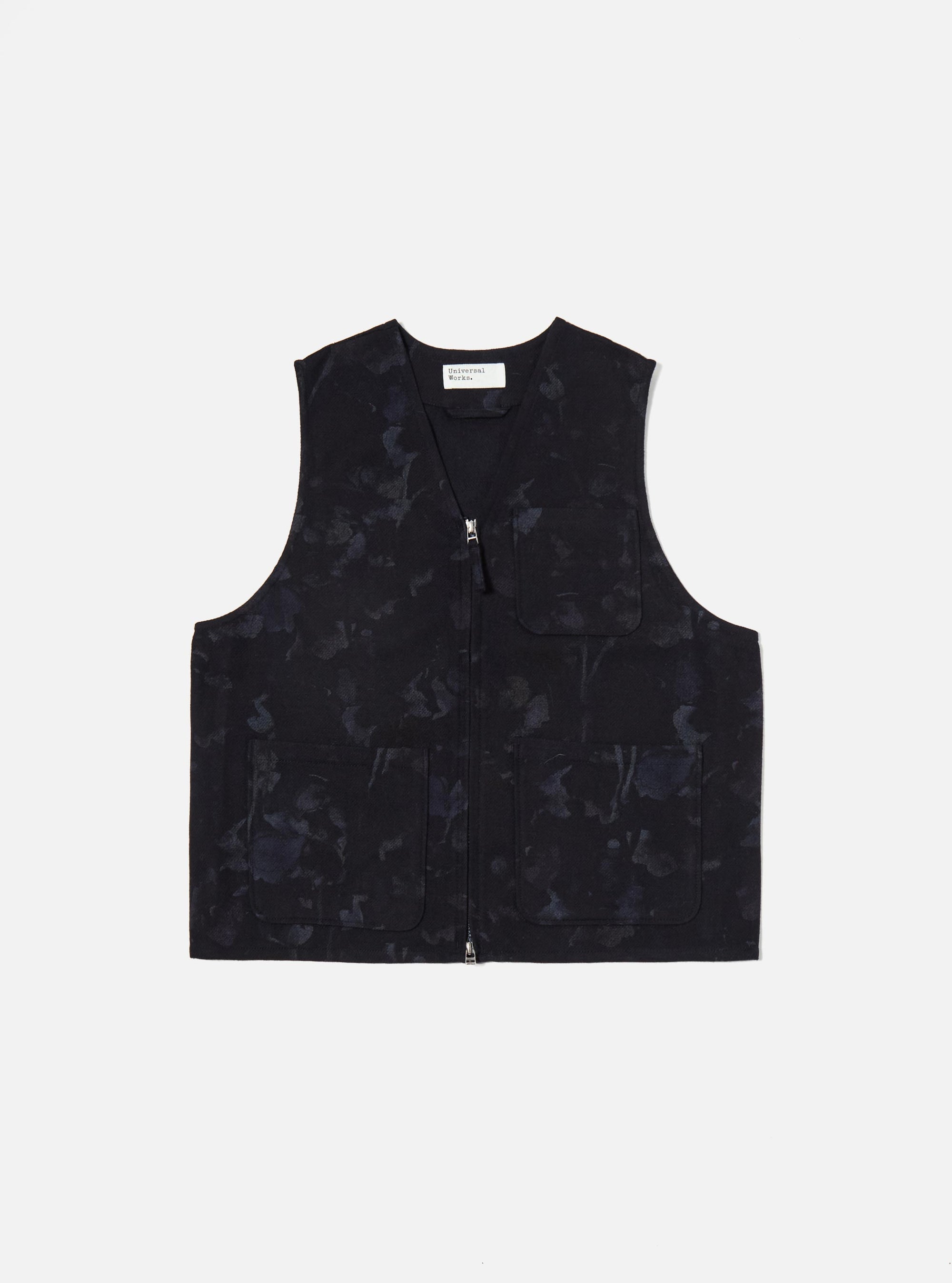 The Navy Flower Print Flannel Operators Gilet, a dark vest with a floral pattern, is displayed on a white background. The gilet has a zip front and pockets.
