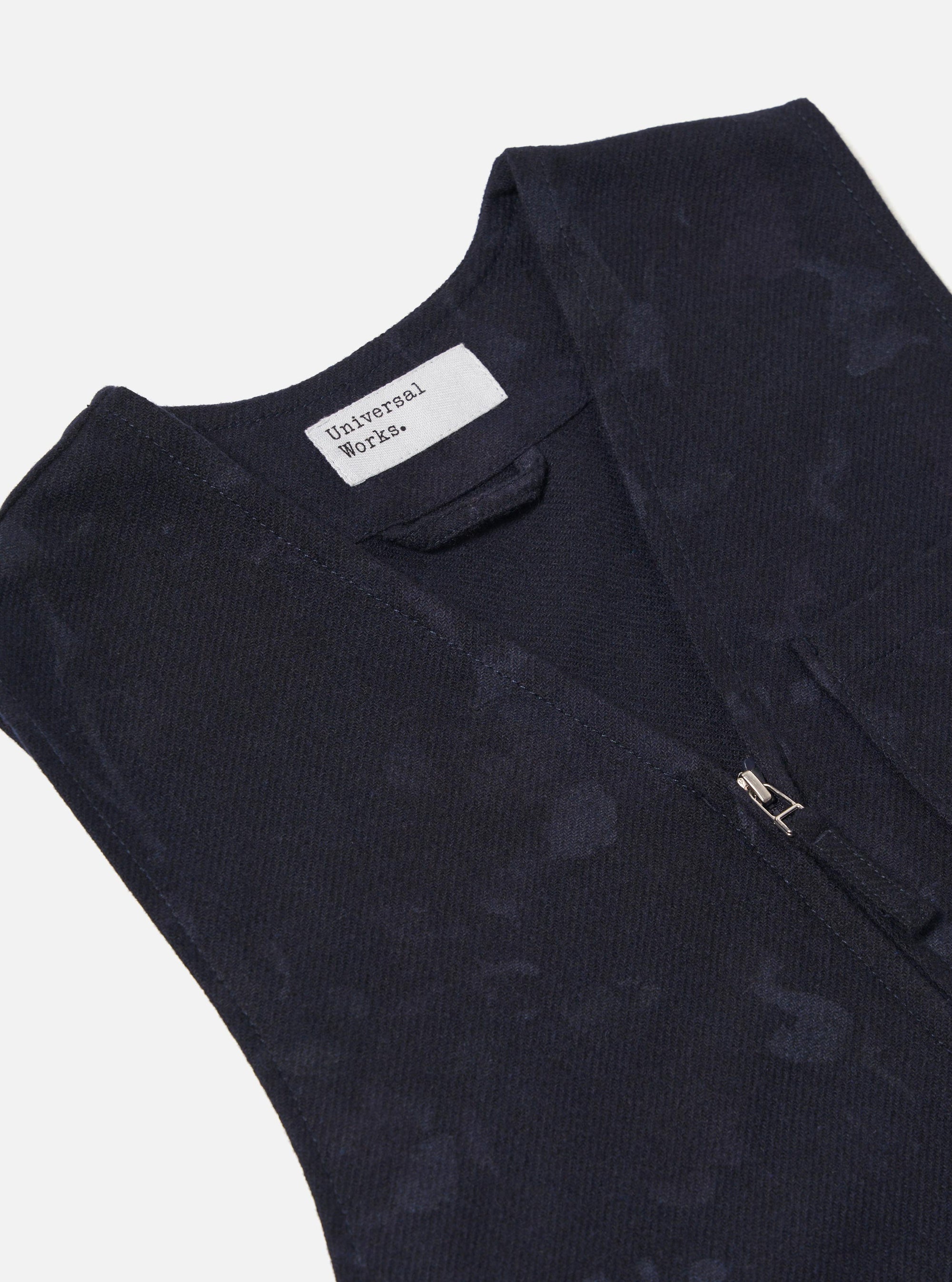 Close-up of the Navy Flower Print Flannel Operators Gilet on a white background. The gilet is navy with a subtle flower print and a silver zipper.