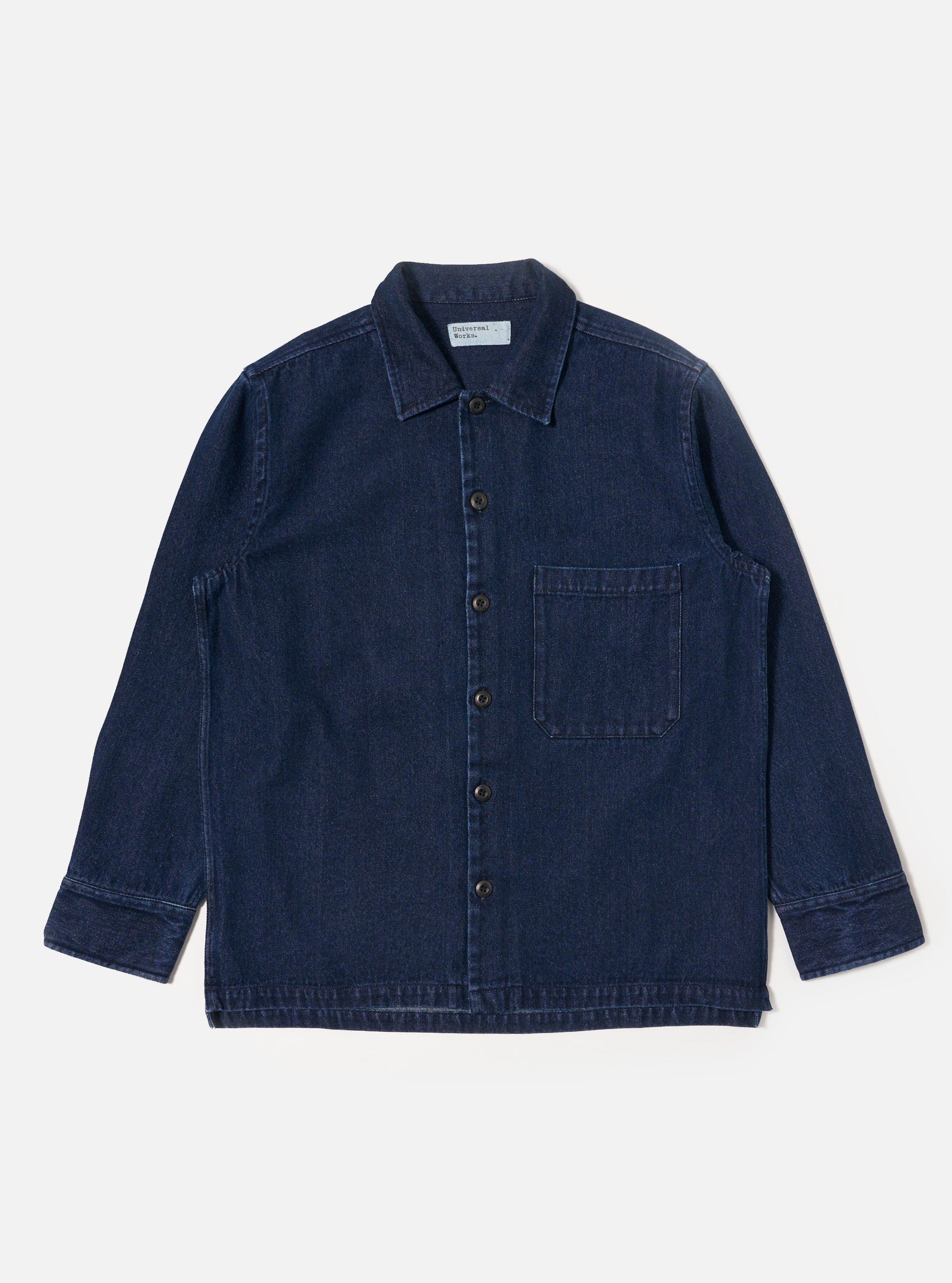 The Indigo Work Denim Fatigue Shirt is displayed on a white background. The shirt is a dark indigo color and has a button-down front and a single chest pocket.
