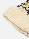 Close-up of an Ecru/Navy British Wool Short Watch Cap on a white background. The cap features a knit pattern with ecru, navy, and gold colors.