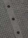 Close-up of the grey textured Merino knit Charlie Cardigan, showing the knit pattern and button detail. The cardigan is laid flat on a neutral surface.