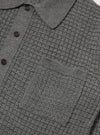 Close-up of the grey textured Merino knit Charlie Cardigan on a white background. Shows the knit detail, buttons, and pocket.