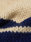 Close-up of the Sand Chunky Knit Stripe Lenny Scarf. Features a chunky knit in sand and navy stripes. The scarf is soft and warm, perfect for cold weather.