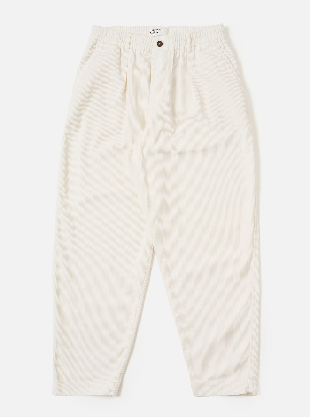 The Ecru Cord Pleated Track Pant in ecru corduroy, laid flat on a white background. These stylish, comfortable pants feature a relaxed fit and subtle pleats.