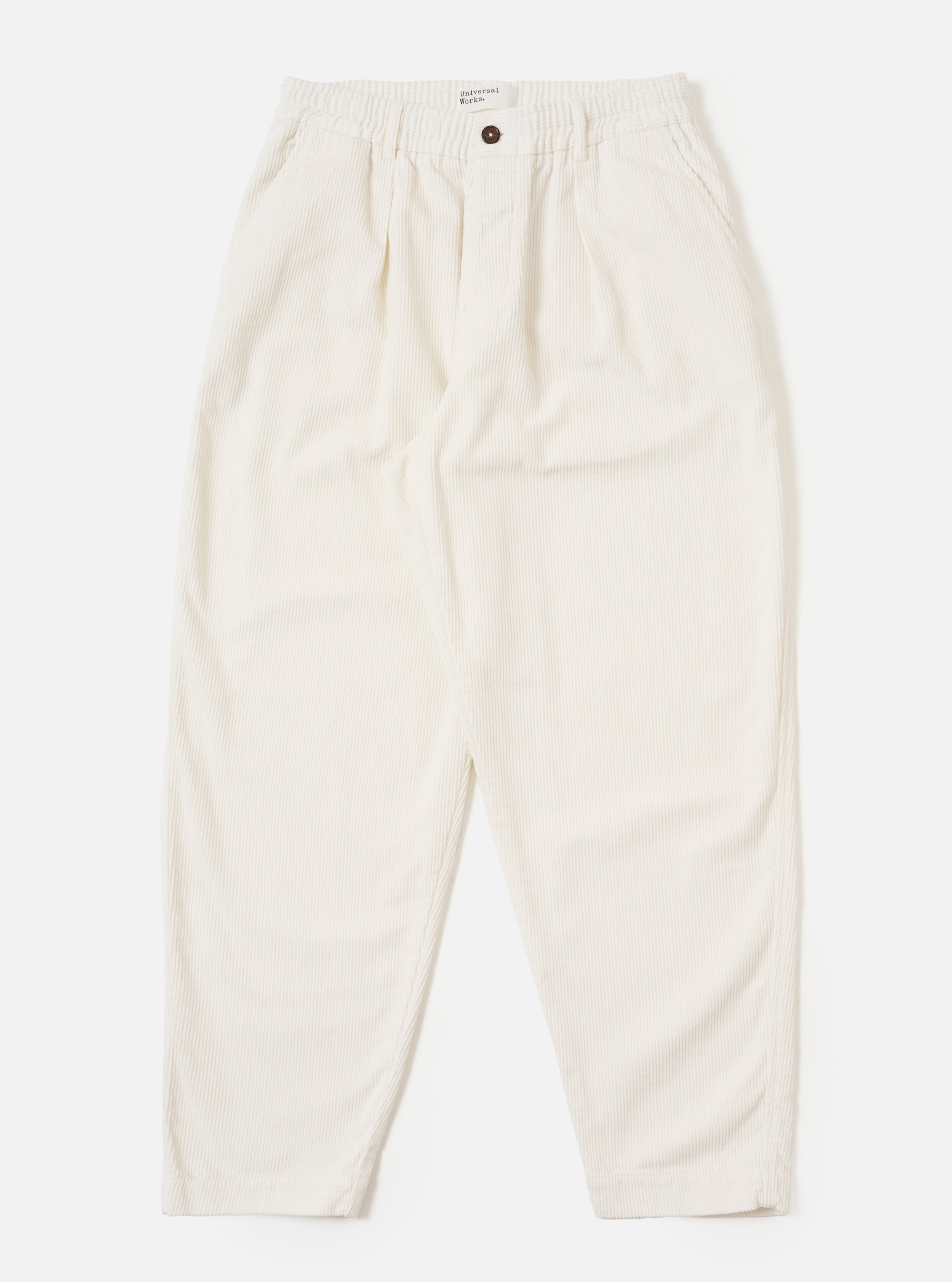 The Ecru Cord Pleated Track Pant in ecru corduroy, laid flat on a white background. These stylish, comfortable pants feature a relaxed fit and subtle pleats.