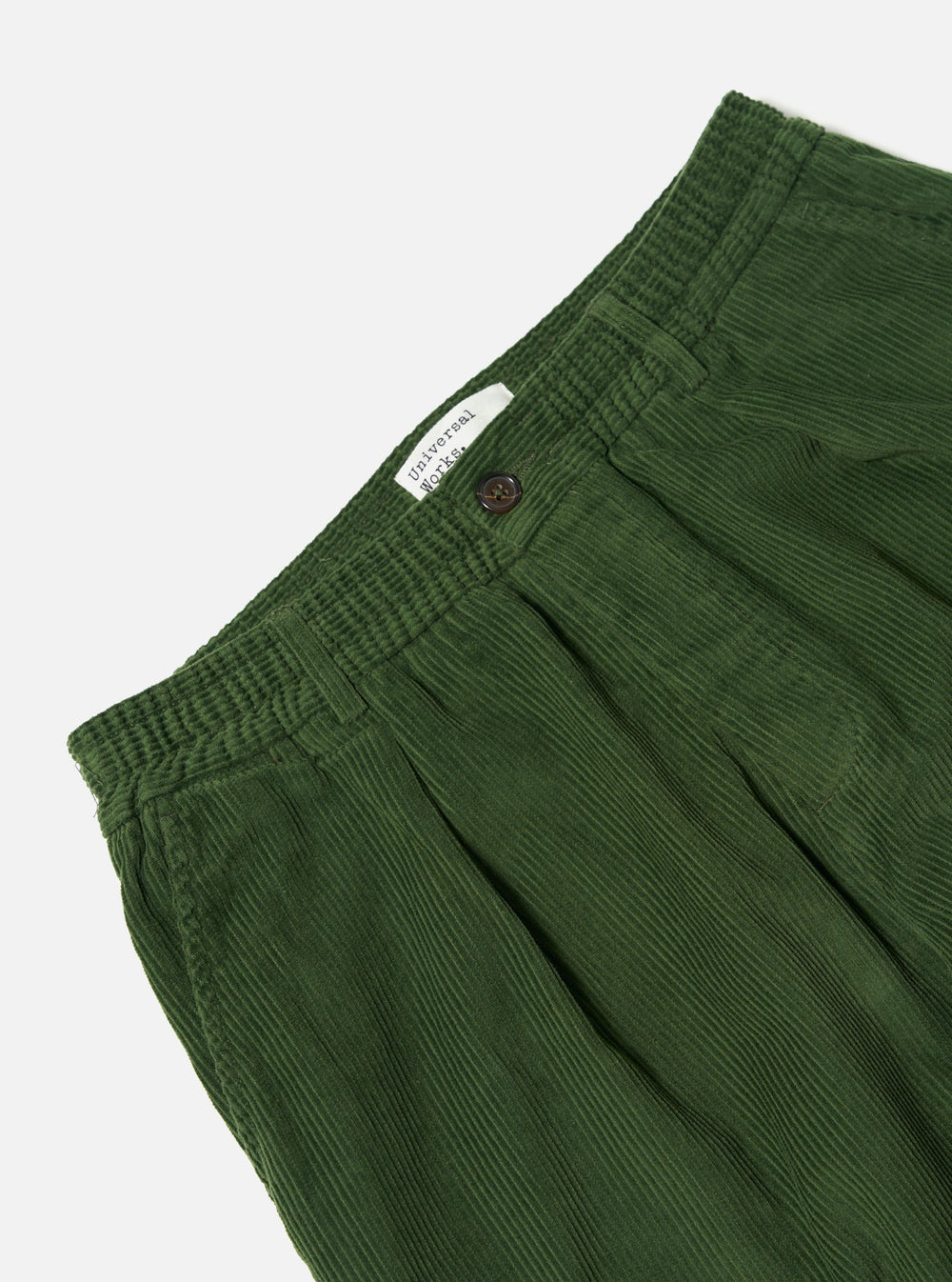 Close-up of the Green Cord Pleated Track Pant on a white background. Shows the corduroy texture and pleated design.