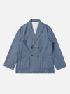 The Indigo Denim Herringbone Manor Jacket, a blue denim jacket with a herringbone pattern, is laid flat on a white background. The jacket is double-breasted with four buttons.