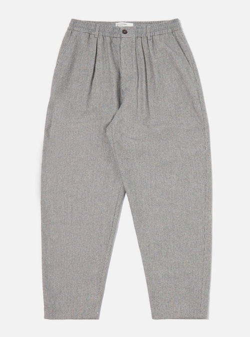The Grey Leon Tweed Pleated Track Pant, showcased on a clean white backdrop. These stylish pants feature a comfortable fit and a classic tweed pattern.