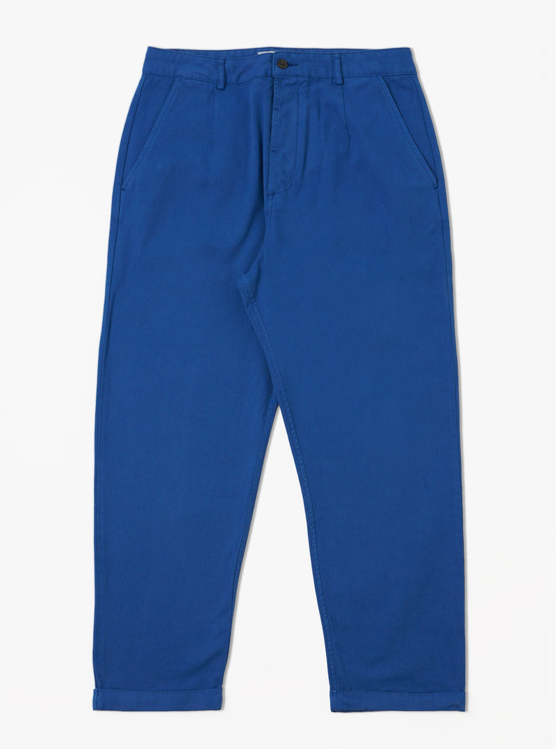 The Navy Derek Twill Super Chino, a pair of blue twill pants, is laid out on a white background. The pants have a relaxed fit and cuffed hems.