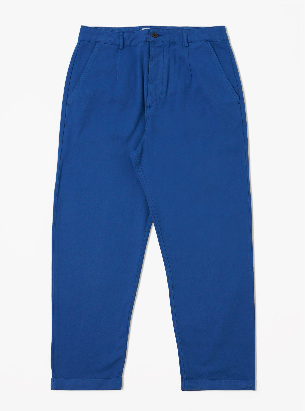The Navy Derek Twill Super Chino, a pair of blue twill pants, is laid out on a white background. The pants have a relaxed fit and cuffed hems.