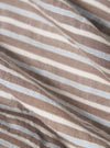 Close-up of the Brown Madison Check/Stripe Station Shirt fabric. Features brown, white, and light blue stripes. The shirt is artfully draped on a flat surface.