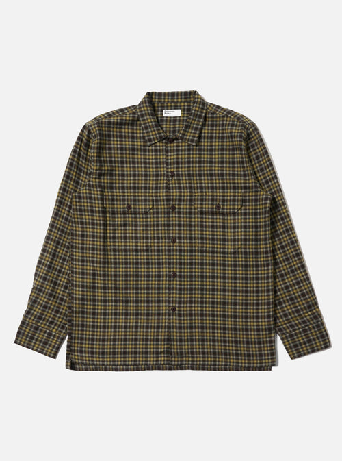 The Brown Bang Check Utility Shirt is laid flat on a white background. The shirt is a brown, yellow, and white plaid with long sleeves and two chest pockets.