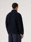 Back view of a man wearing the Navy Alvar Fleece Lancaster Jacket. The jacket is fleece and the background is a plain white.