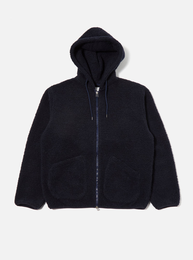 The Navy Alvar Fleece Travel Hoodie is displayed on a white background. The hoodie is a deep navy color and has a full zip front with a drawstring hood.