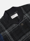 Close-up of the Grey Moh Check Fleece Button Front Bomber. Features a black collar, button closure, and a grey and black check pattern. The background is a plain white.