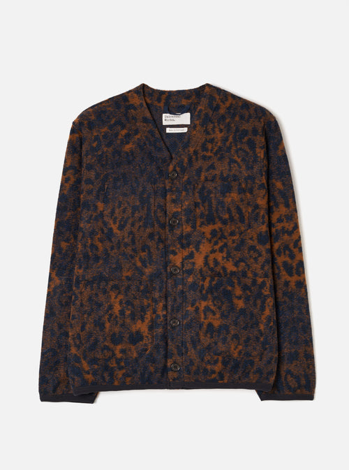 A male model stands against a plain studio background wearing the Dark Navy/Brown Night Leopard Cardigan. The image features the button front, v-neck collar, front patch pockets, and distinct dark navy and brown leopard print pattern.