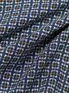 Close-up of the Navy Oscar Cotton L/S Camp Shirt fabric. The shirt features a navy background with a white, black, and orange pattern. The cotton fabric is soft and slightly wrinkled.