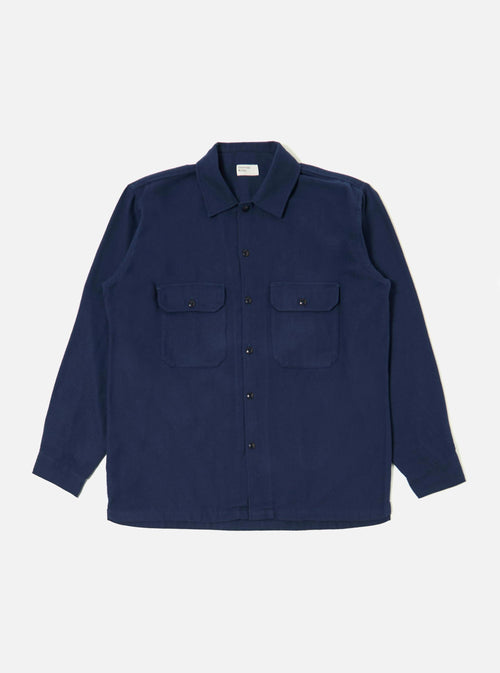 The Navy Alaska Cotton Utility Shirt, in a dark blue cotton, is laid flat on a white background. The shirt has two chest pockets and a button-up front.