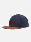 The Navy/Brown Canvas Baseball Hat on a clean white background. The hat has a brown brim and a navy canvas top with brown embroidered letters.