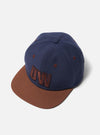 Navy/Brown Canvas Baseball Hat on a white background. The hat has a brown brim and a navy blue crown with brown embroidered details.