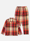 The Red Earth Check Long Pyjama Set on a white background. The set features a red, orange, and cream check pattern. The top is a button-down shirt with a pocket.
