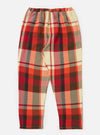 Close-up of the Red Earth Check Long Pyjama Set. Features a red, orange, cream, and brown plaid pattern. Elastic waist. On a white background.