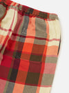 Close-up of the Red Earth Check Long Pyjama Set. Features a red, orange, brown, and cream plaid pattern. Elastic waist and pocket detail. Shot on a white background.