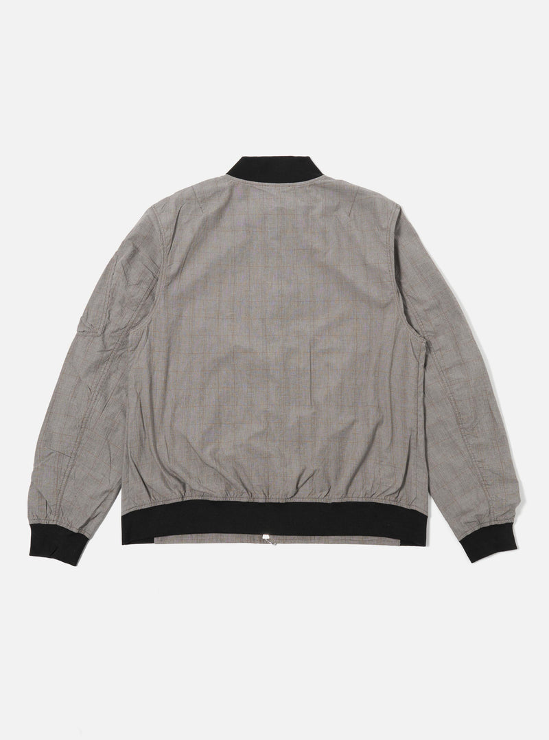 The Grey Brown Wales Glen Check NS Bomber Jacket is shown from the back as a flat lay against a white background. The jacket features a prominent glen check pattern in shades of grey and brown, with a ribbed collar, ribbed hem, and set-in sleeves.