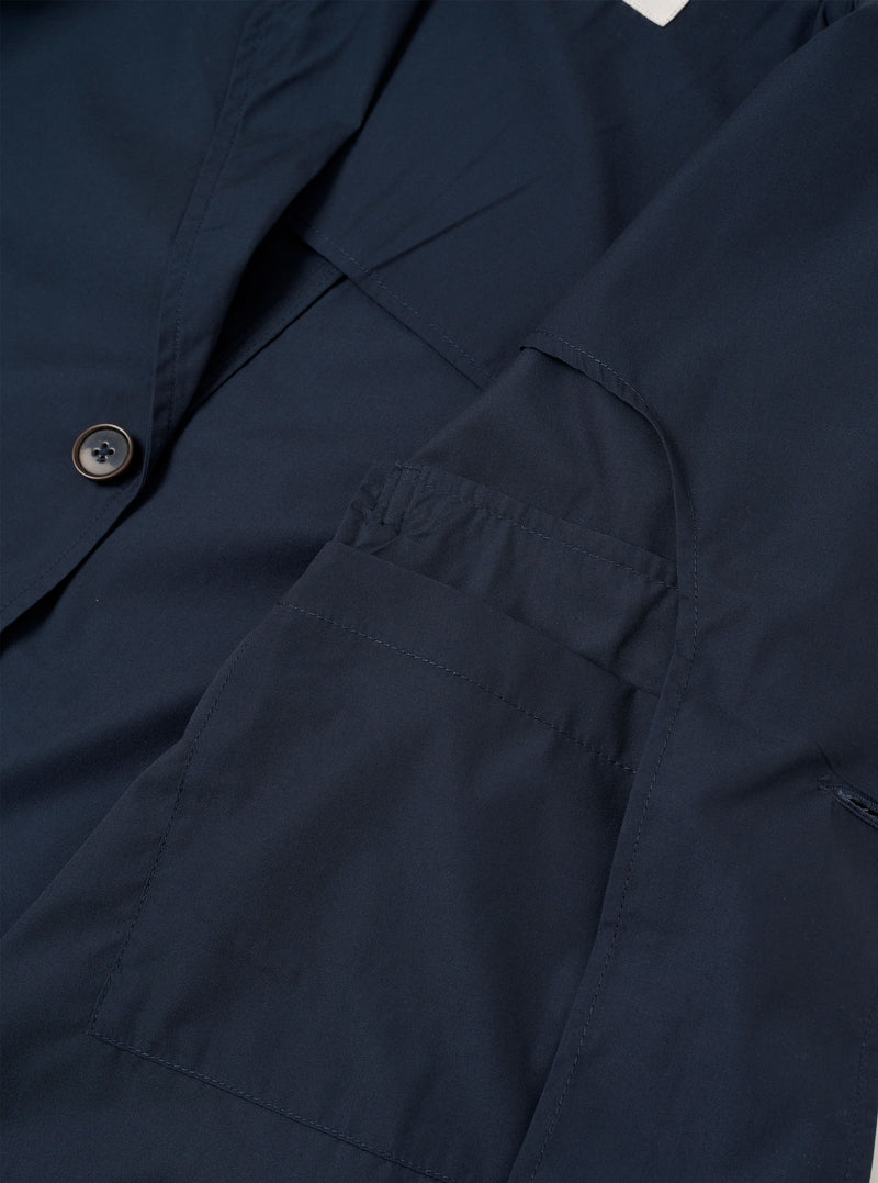 The Navy Recycled Polytech Capitol Jacket is shown from the back as a flat lay against a plain white background. The image highlights the clean construction of the shoulders, the straight hem, and the smooth texture of the recycled polytech fabric.