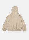 The Sand Cotton Recycled Nylon Mix Daley Jacket is shown from the back as a flat lay against a plain white background. The image highlights the jacket's loose, blouson fit, oversized sleeves, and panelling detail across the shoulders and back. The sand-colored fabric has a smooth finish.