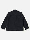 The Black Organic Fine Cord Duty Jacket is shown from the back as a flat lay against a plain white background. The image highlights the jacket's oversized fit, loose sleeves with darting at the elbows, and a curved rear hem. The fine-wale organic cotton corduroy texture is visible throughout the garment.