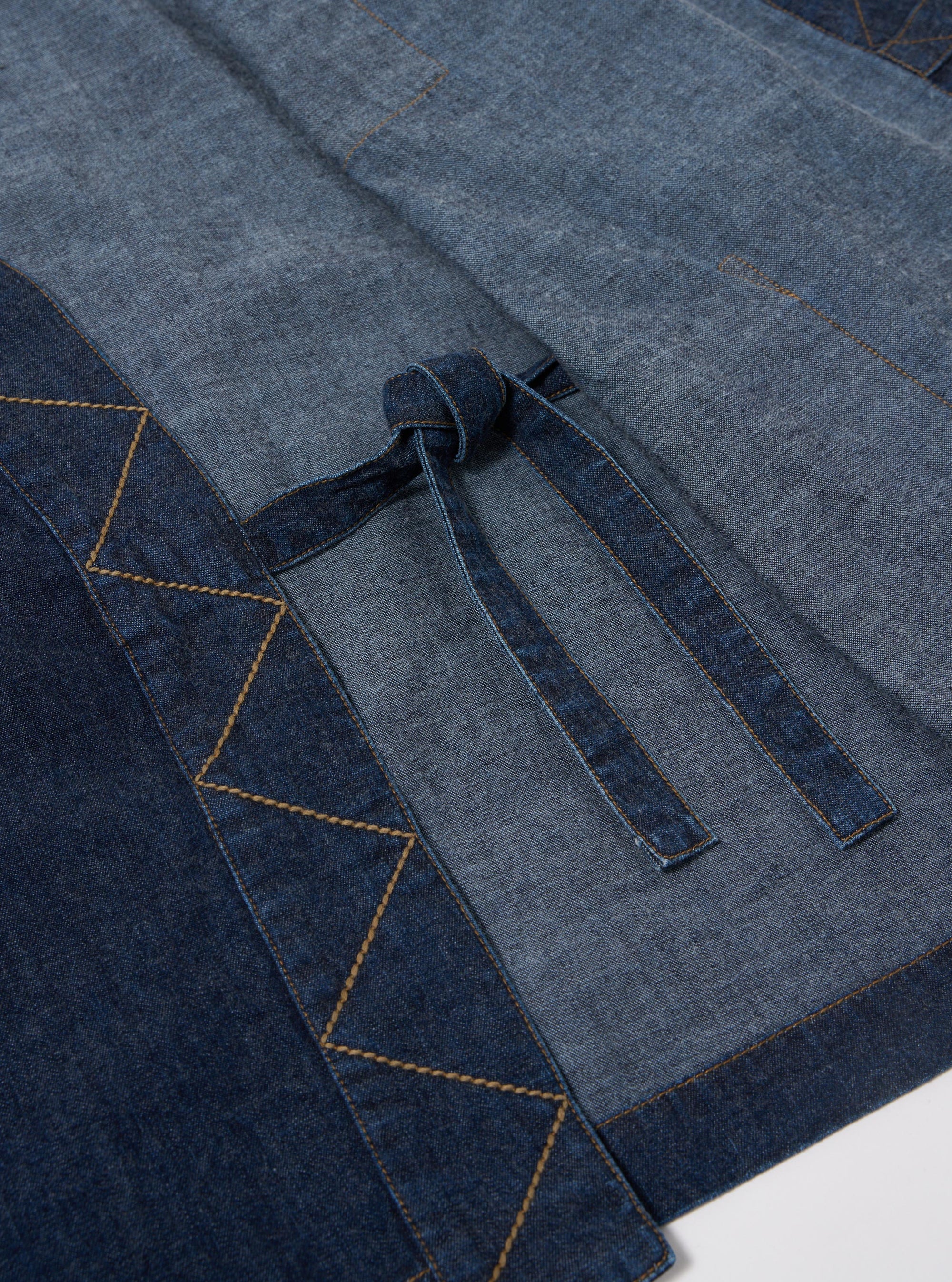 The Indigo Kaihara LT WT Denim Kyoto Work Jacket is shown from a rear angle as a flat lay against a plain white background. The jacket features a straight hem and a loose, unstructured fit. The deep indigo denim fabric has a visible texture.