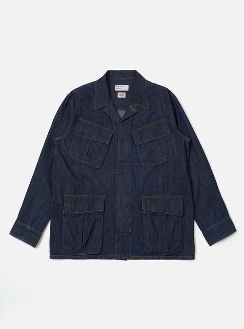 The Indigo Kaihara LT WT Denim Jungle Jacket is shown as a flat lay against a white background. The jacket features four large front patch pockets with flap closures, a central button-down front, and a structured collar. The garment is made from a dark indigo blue lightweight denim with visible stitching details throughout.