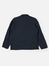 The Navy Twill Manor Jacket is shown from a rear angle as a flat lay against a plain white background. The image highlights the double vents at the hem and the structured silhouette of the navy cotton twill fabric.