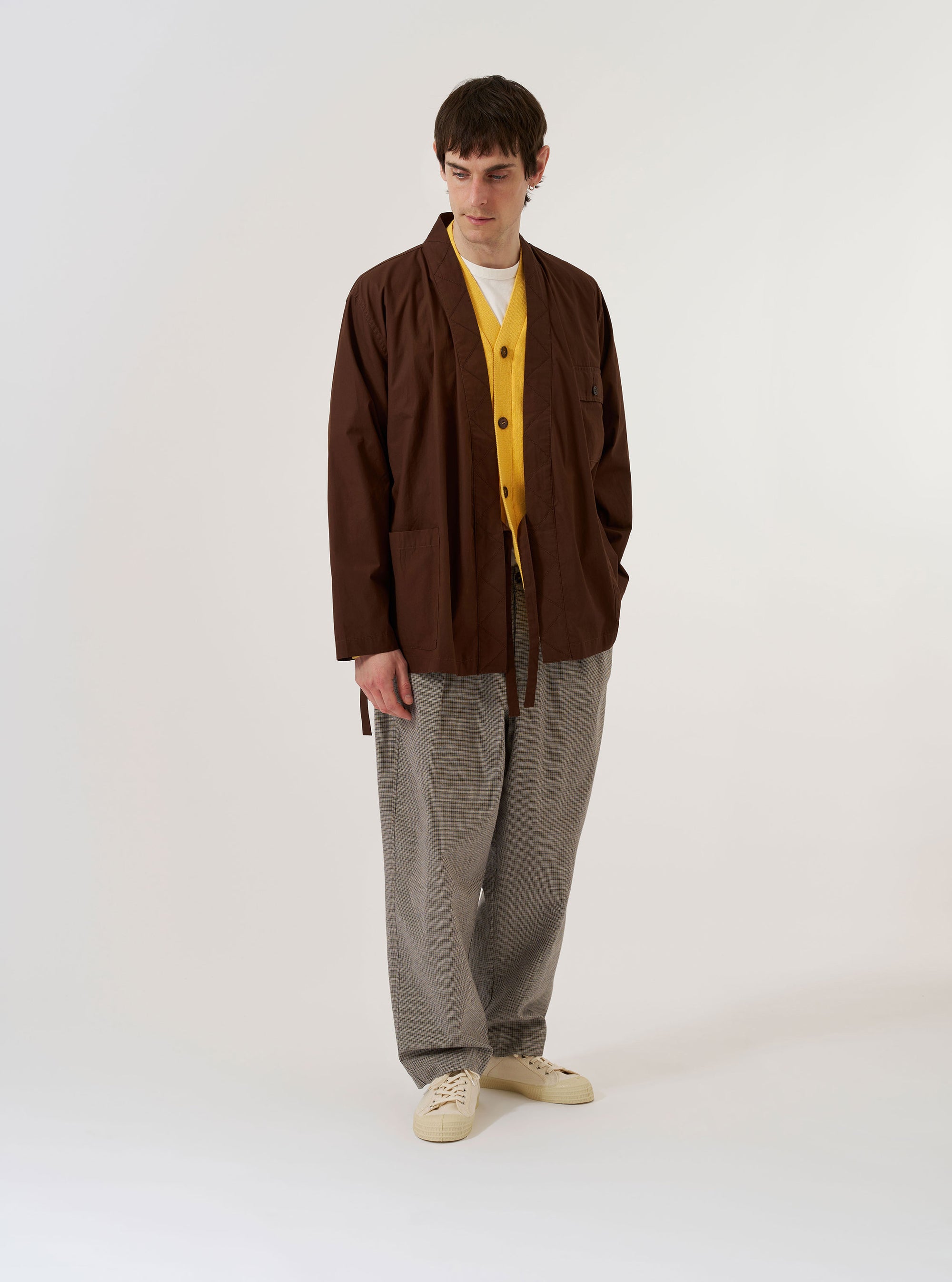 The Brown Peached Poplin Osaka Work Jacket is shown as a flat lay against a plain white background. The jacket features a wrap-front design with internal and external tie closures, two chest patch pockets with one featuring a buttoned flap, and two large lower patch pockets. The design includes a kimono-style collar and military-inspired contrast embroidery.