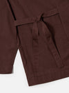 The Brown Peached Poplin Osaka Work Jacket is shown from the back as a flat lay against a plain white background. The image highlights the clean, simple construction of the garment's rear, featuring a straight hem and the smooth, matte finish of the brown cotton poplin fabric.