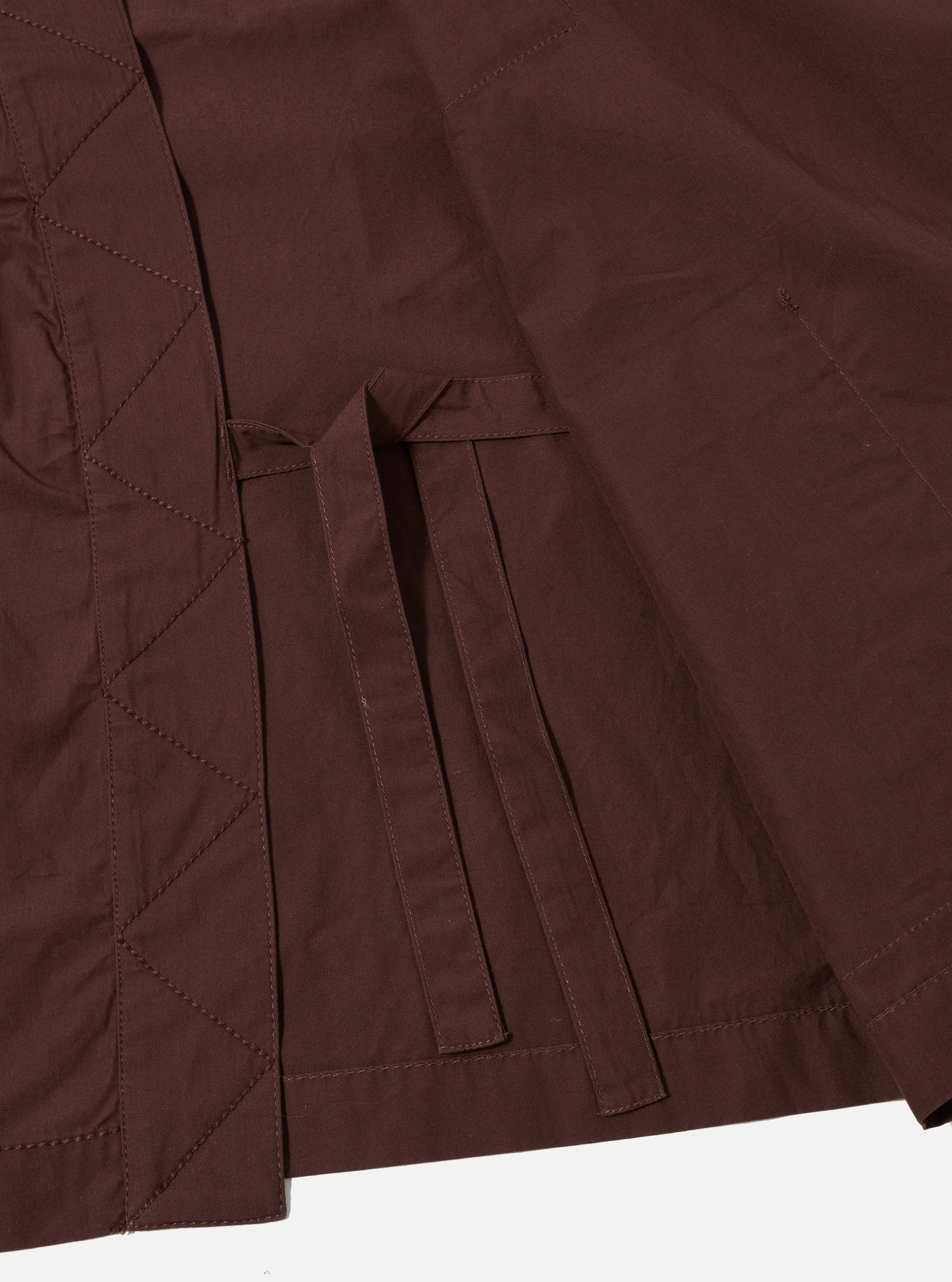 The Brown Peached Poplin Osaka Work Jacket is shown from the back as a flat lay against a plain white background. The image highlights the simple, clean construction of the garment's rear panel, the wrap-style kimono collar, and the soft, matte texture of the brown peached poplin fabric.