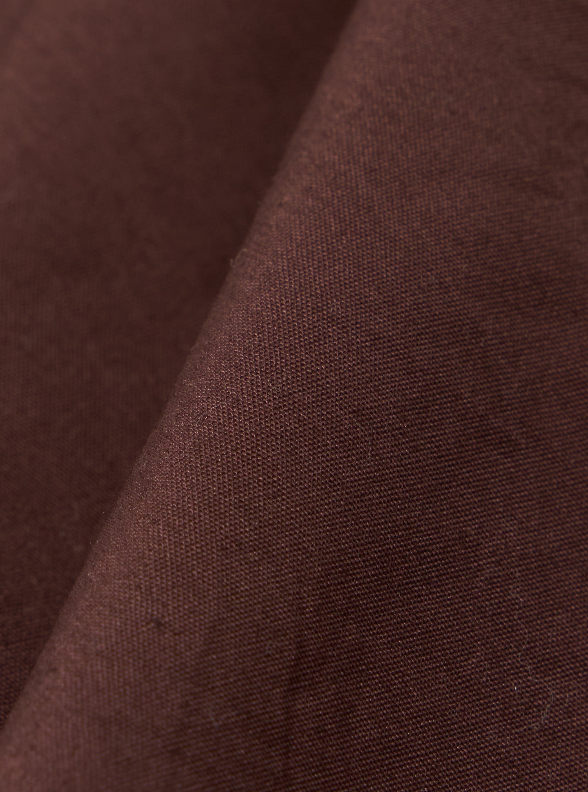 A close-up swatch image of the Brown Peached Poplin Osaka Work Jacket fabric displays a solid brown color with a soft, peached texture. The cotton poplin material fills the frame, highlighting the matte finish and fine weave.