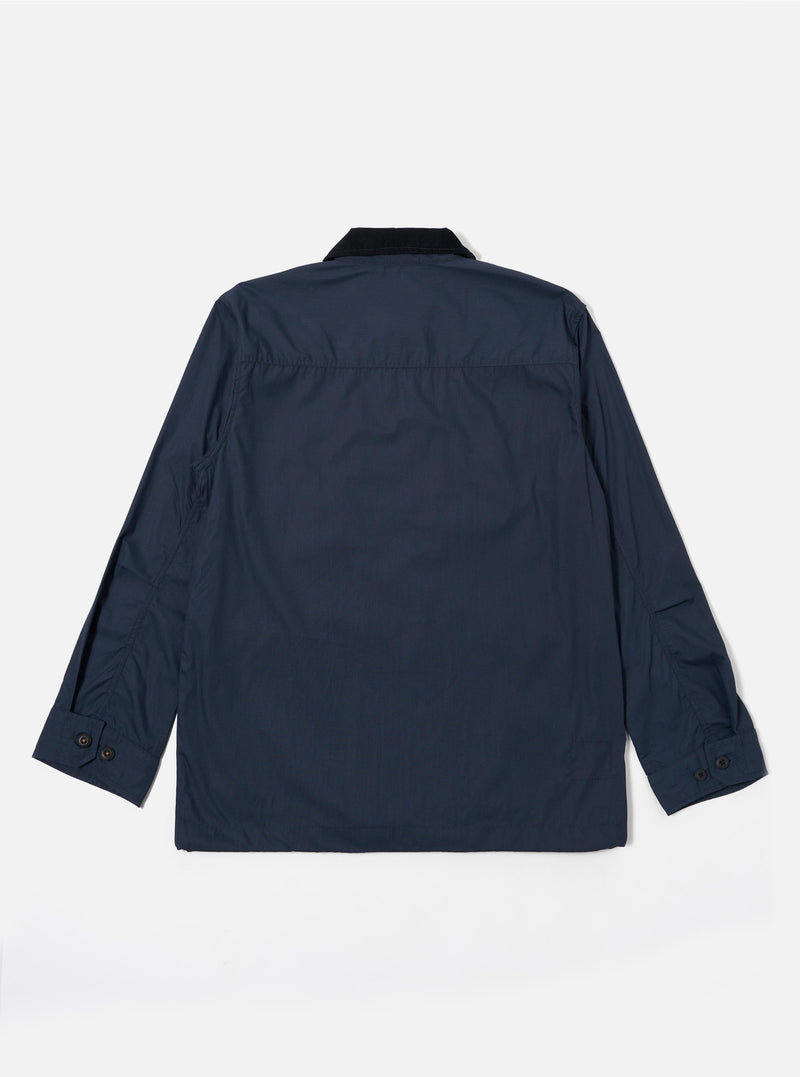 The Navy Recycled Polytech Parachute Field Jacket is shown from the back as a flat lay against a plain white background. The image highlights the smooth, dark navy technical fabric, the contrasting dark corduroy collar, and the adjustable drawcord visible at the straight hem. The long sleeves feature adjustable button cuffs.