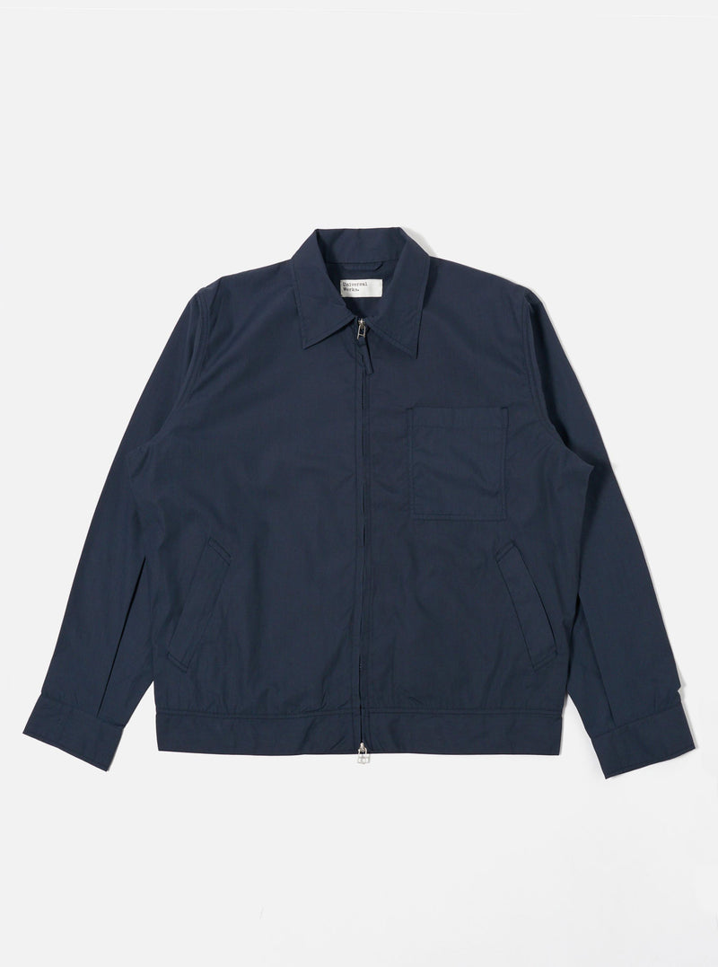 The Navy Recycled Polytech Rose Bowl Jacket is shown as a flat lay against a plain white background. The jacket features a central two-way zip-front closure, a slightly oversized collar, one large patch pocket on the left chest, and two welt pockets at the waist. The navy blue recycled polytech fabric has a smooth, technical appearance.