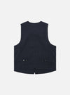 The Dark Navy Ospina Cotton Field Waistcoat is displayed as a flat lay from a side angle against a plain white background. The image highlights the side profile and the armhole of the garment, showcasing the multi-pocket design and the textured dark navy seersucker fabric.
