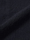 A close-up fabric swatch of the Dark Navy Ospina Cotton Field Waistcoat is shown, highlighting the deep navy blue color and the distinct puckered texture of the seersucker fabric.