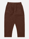The Brown Peached Poplin Dutch Pant is shown as a flat lay against a white background. The trousers feature a wide, voluminous leg, a button fly, and two large front pockets. The fabric is a smooth, matte brown cotton poplin.