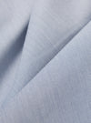 A close-up fabric swatch of the Navy Kennedy Stripe Hi Water Trouser displays a dark navy blue base with thin, vertical white stripes. The detailed view highlights the fine weave of the cotton fabric and the consistent spacing of the pinstripe pattern.