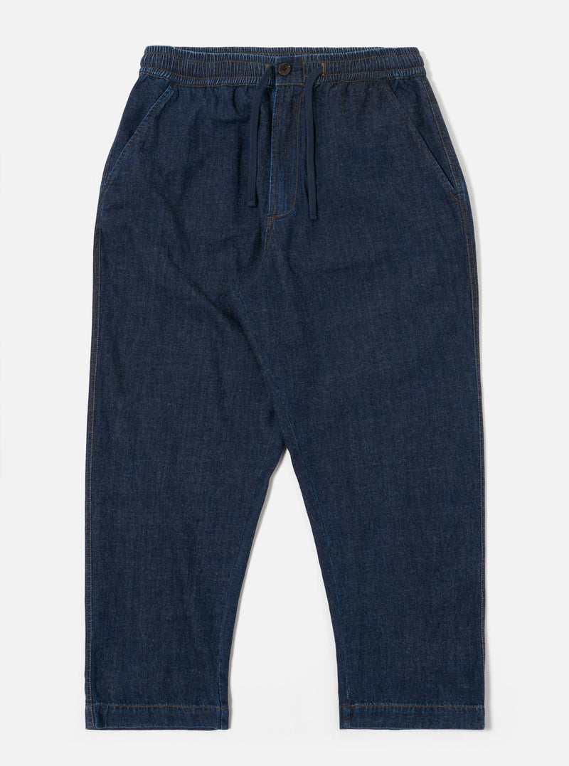 The Indigo Kaihara LT WT Denim Hi Water Trouser is shown as a flat lay against a white background. The trousers feature an elasticated waistband with an adjustable drawstring, two slanted side pockets, and a slightly cropped leg. The indigo blue denim fabric has a smooth, lightweight appearance.