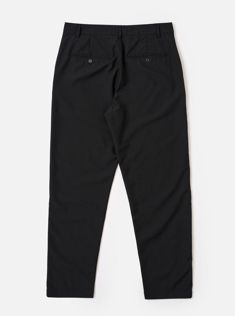 The Black Tropical Suiting Military Chino is shown from a rear angle as a flat lay against a plain white background. The image highlights the two rear jetted pockets with button closures and the clean, straight-leg construction of the trousers.