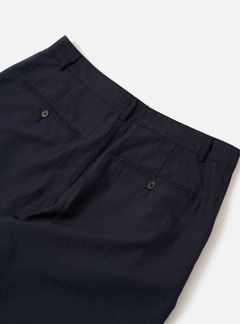 The Navy Tropical Suiting Military Chino is shown from the back as a flat lay against a plain white background. The trousers feature two rear jetted pockets with button closures, belt loops, and a clean, straight-leg silhouette. The navy blue fabric is a smooth tropical suiting with a lightweight appearance.