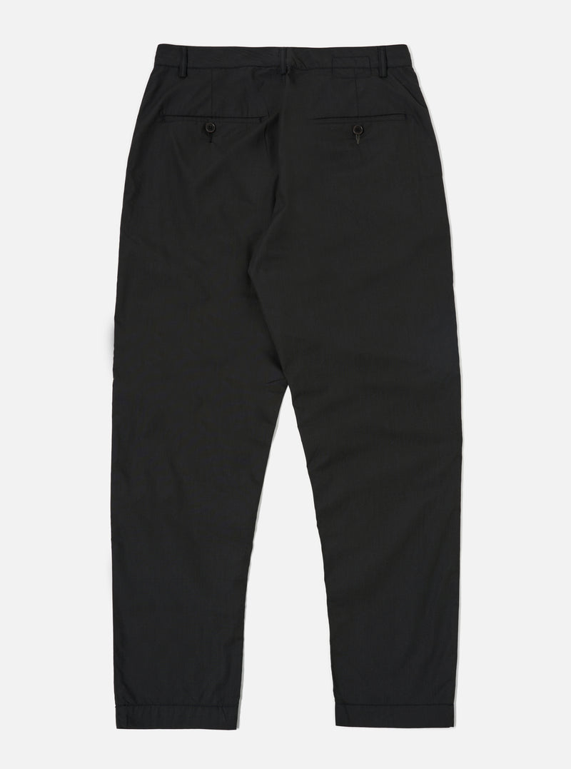 The Black Recycled Polytech Military Chino is shown from the back as a flat lay against a plain white background. The image highlights the two rear jetted buttoned pockets and the straight-cut design of the legs. The black recycled polytech fabric has a smooth, matte finish.