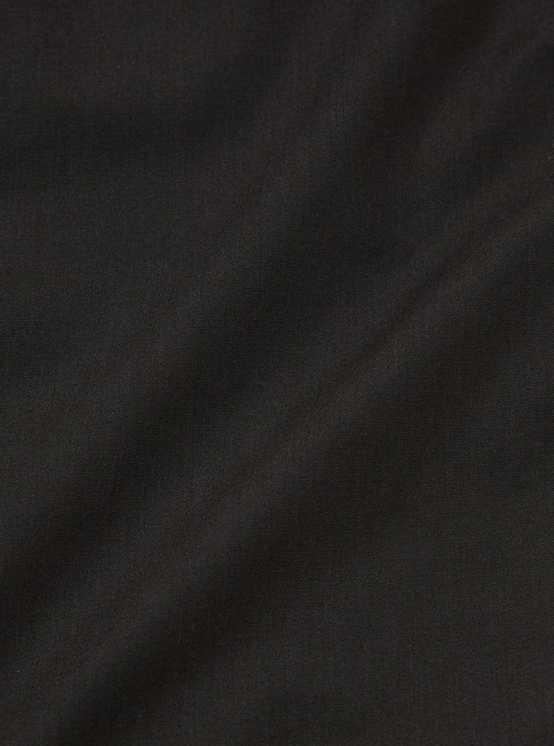 A close-up swatch image of the Black Recycled Polytech Military Chino fabric. The image focuses on the deep black color and the smooth, technical texture of the recycled polyester and cotton blend.