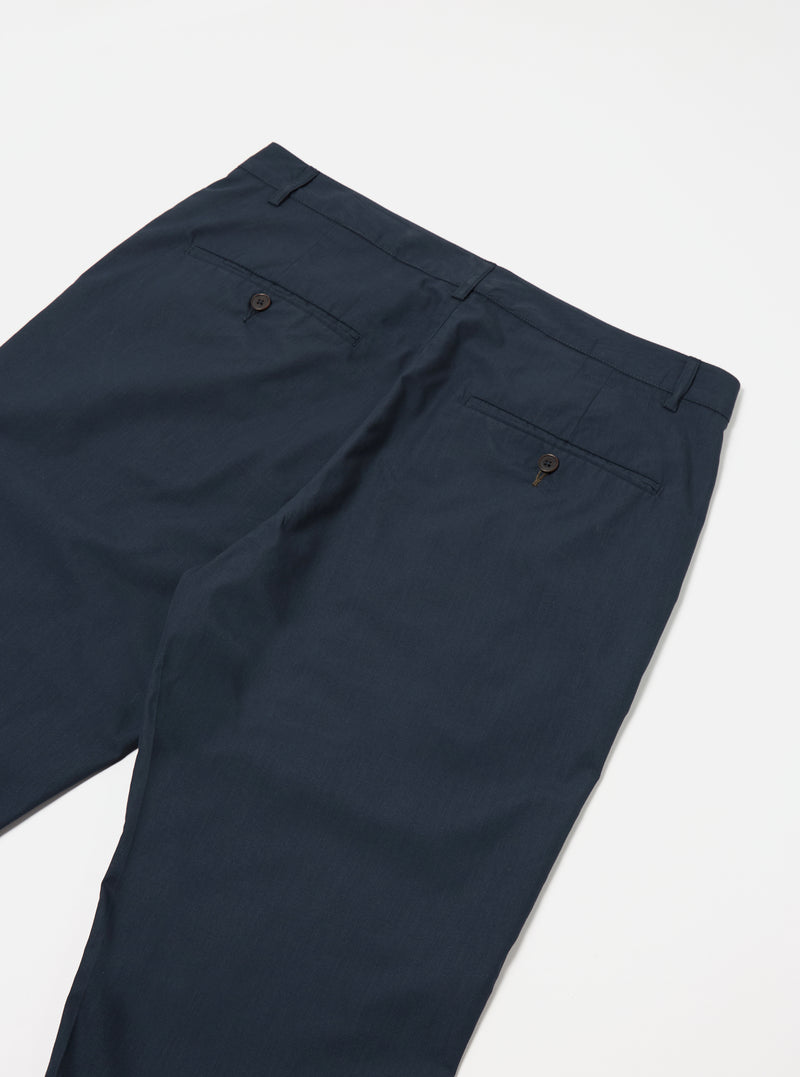 The Navy Recycled Polytech Military Chino is shown from a rear angle as a flat lay against a plain white background. The image highlights the two rear pockets, including one with a button-down flap, and the clean construction of the waistband.